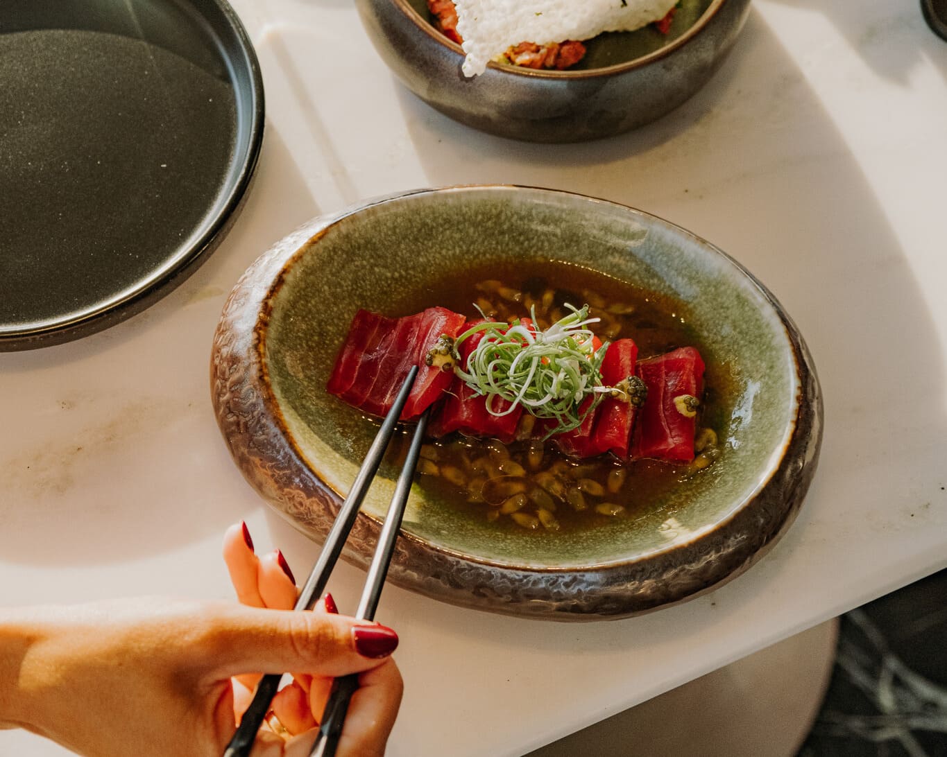 Sora Main Restaurant’s signature seafood, garnished with fresh herbs.
